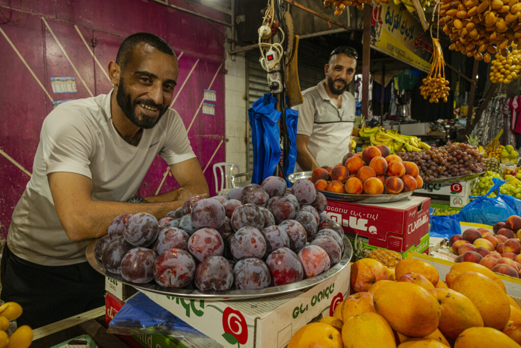 Ramallah, Palestine - Marketplace - two young fruit and vegetable vendors.