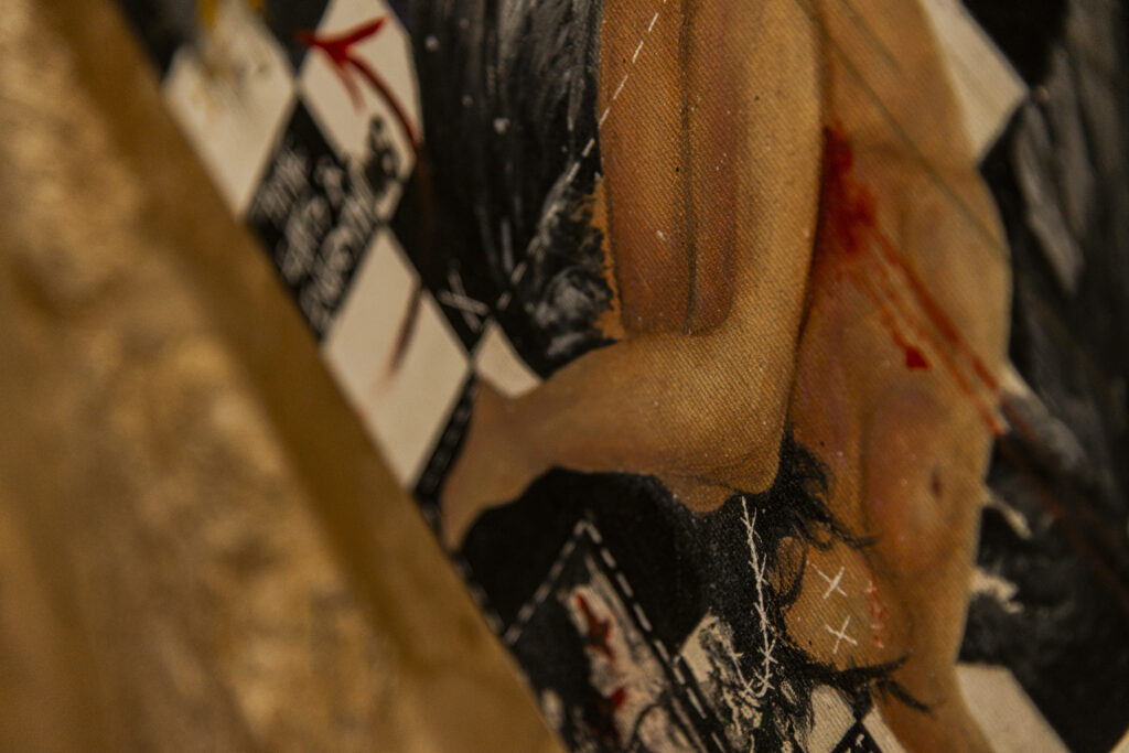 Detail of one of the paintings inside the laboratory of one of the restored cafes of The Yalla Project. In the painting you can recognize the body of a woman, naked and probably killed in a convulsive position on the ground, on a floor of black and white tiles.