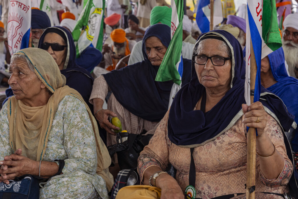 A group of protesting women sit under the marquee that has been erected along the highway leading from Punjab to Delhi, at the Shambhu Border.