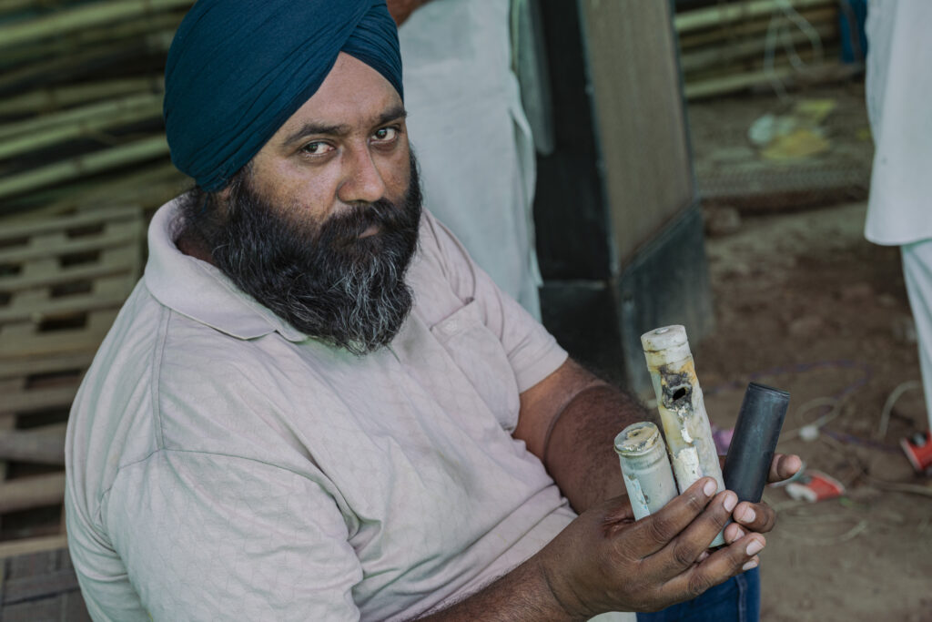 One of the protesters shows some of the shells fired by police during clashes in January. During one of the clashes a 22-year-old farmer was hit in the head by a teargas shell and died.