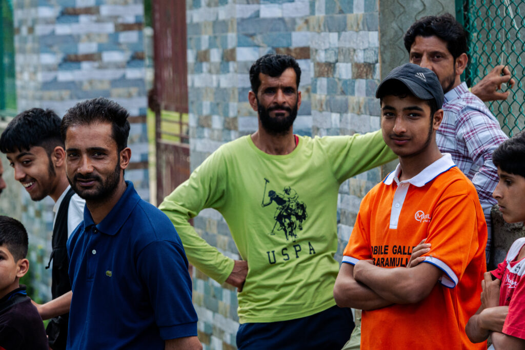 Men gather outside the polling station on the afternoon of May 20, 2024, in Baramulla district.